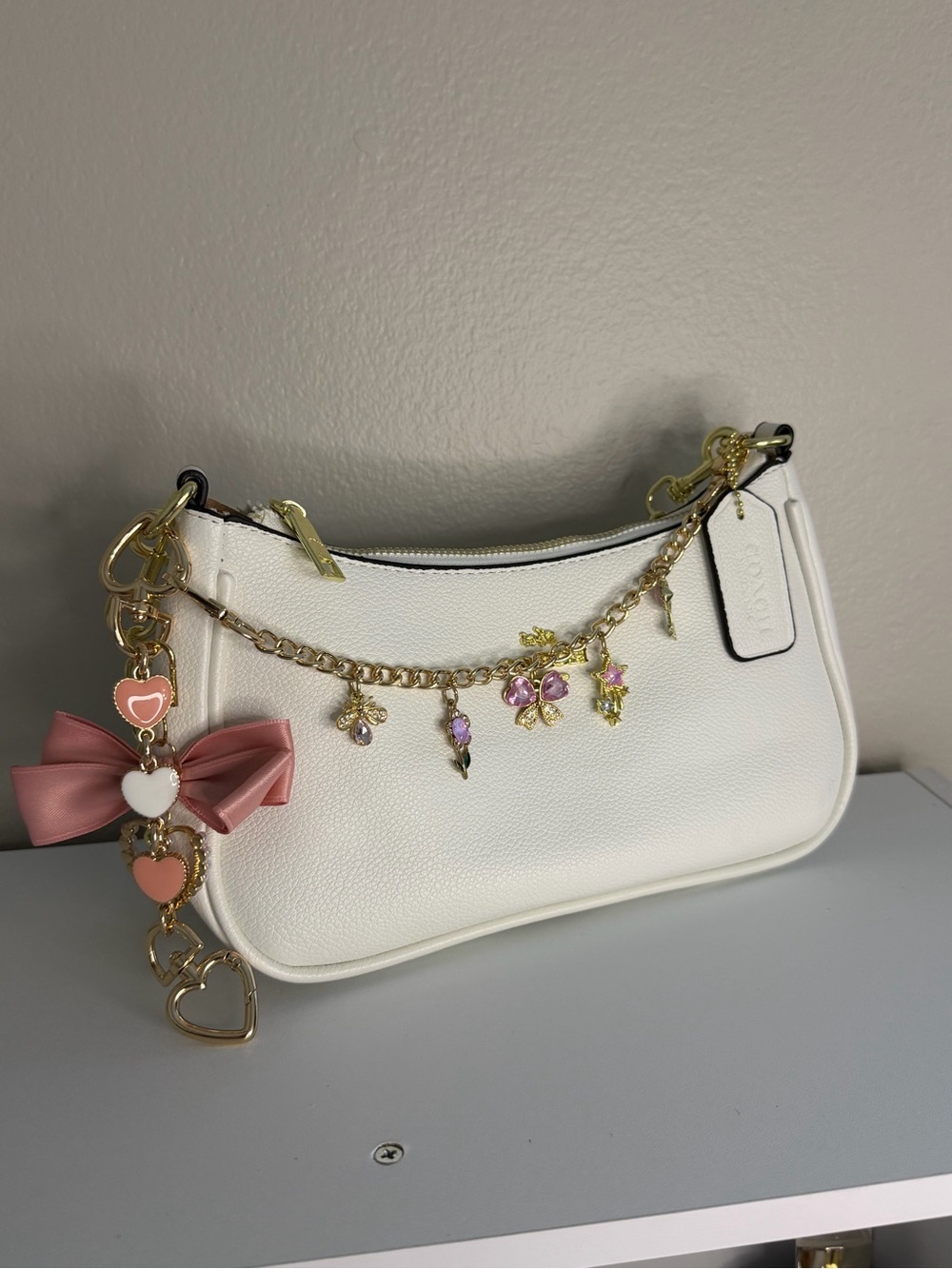 Coach White Pebbled Leather Shoulder Bag with Pink Charm Accents